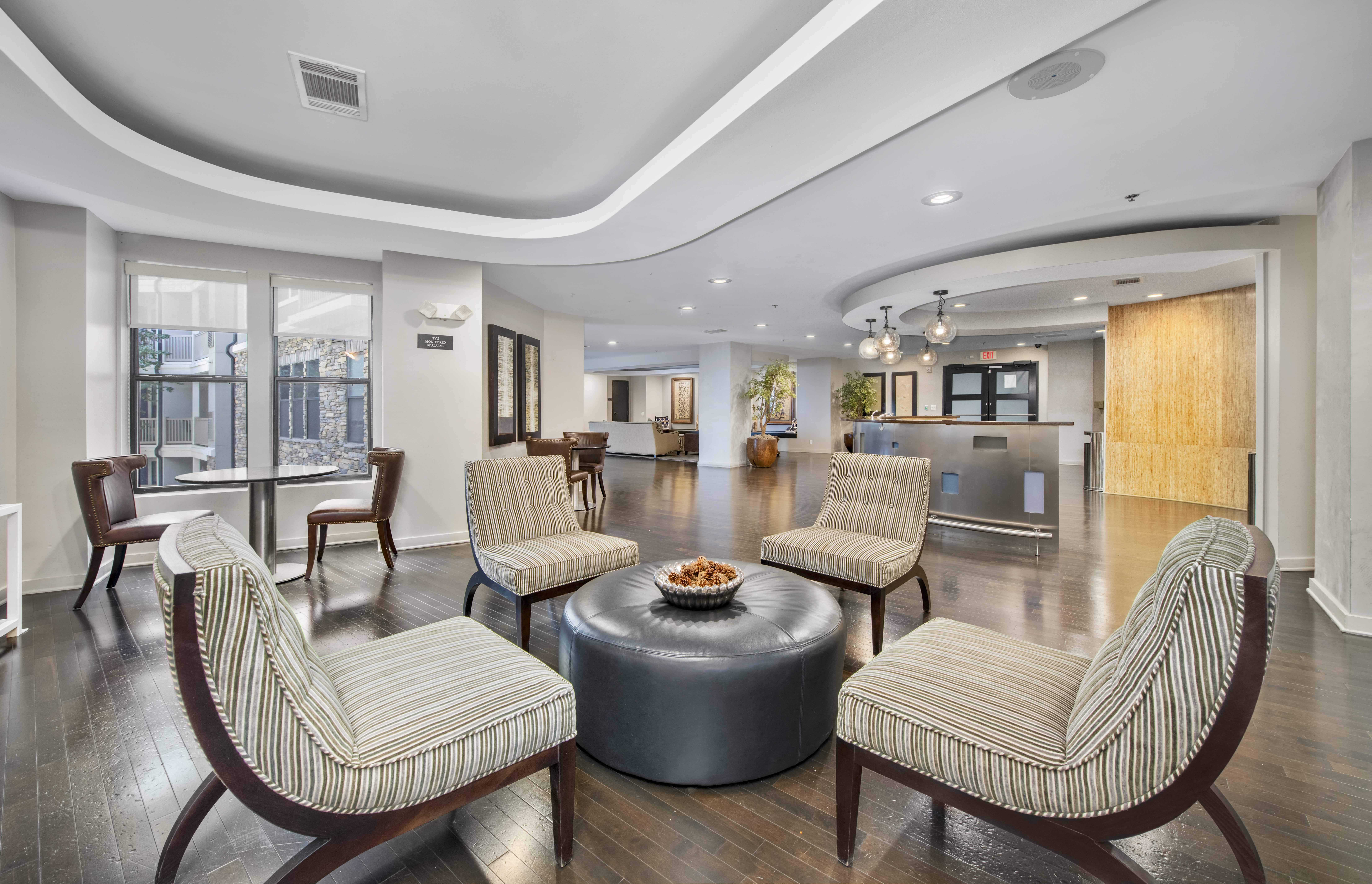 a large living room with chairs and a table